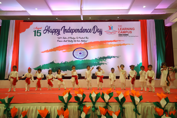 Preschool students in traditional white and saffron attire dancing for Independence Day in Ravet.