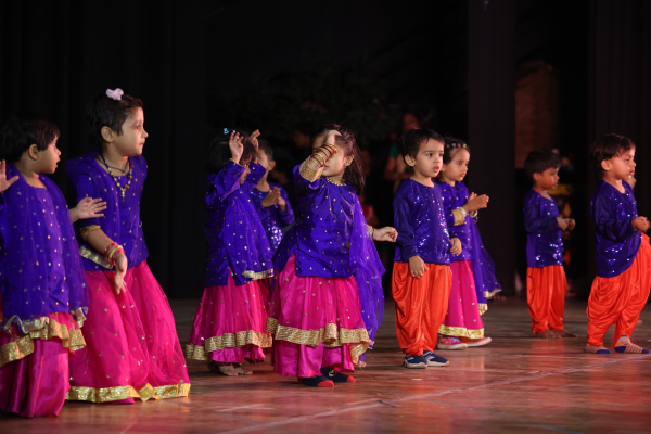 Group of toddlers in colorful ethnic wear performing a folk dance at a school function in Pimpri-Chinchwad.