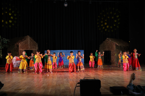 Group of toddlers in colorful ethnic wear performing a folk dance at a school function in Pimpri-Chinchwad.