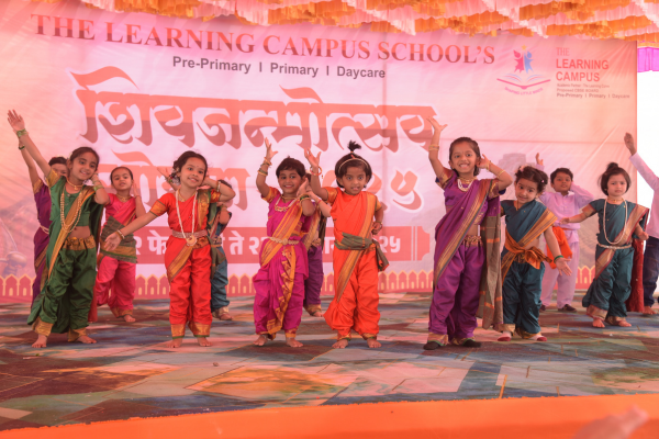 Preschool children performing a traditional dance in colorful ethnic wear during the Shivjayanti Mahotsav at The Learning Campus.